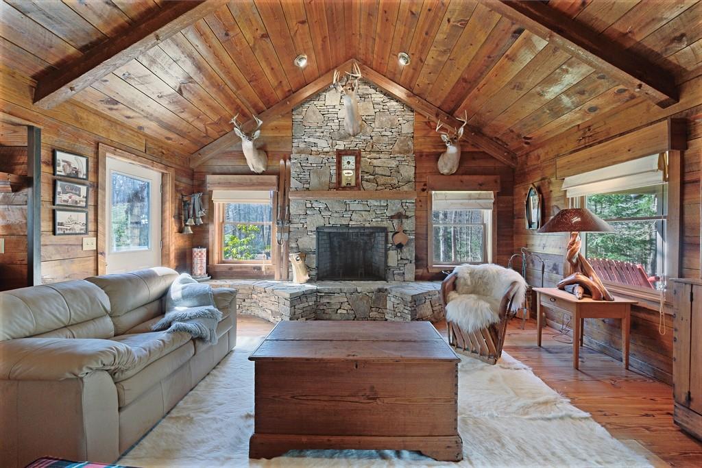 2320 Hardman Road Clarkesville, GA 30523 - Photo 27 of 53 a living room with furniture a fireplace and a large window