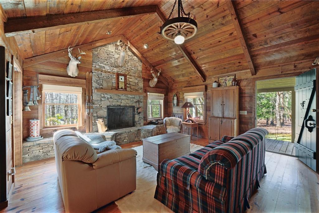 2320 Hardman Road Clarkesville, GA 30523 - Photo 28 of 53 a living room with furniture a fireplace and wooden floor