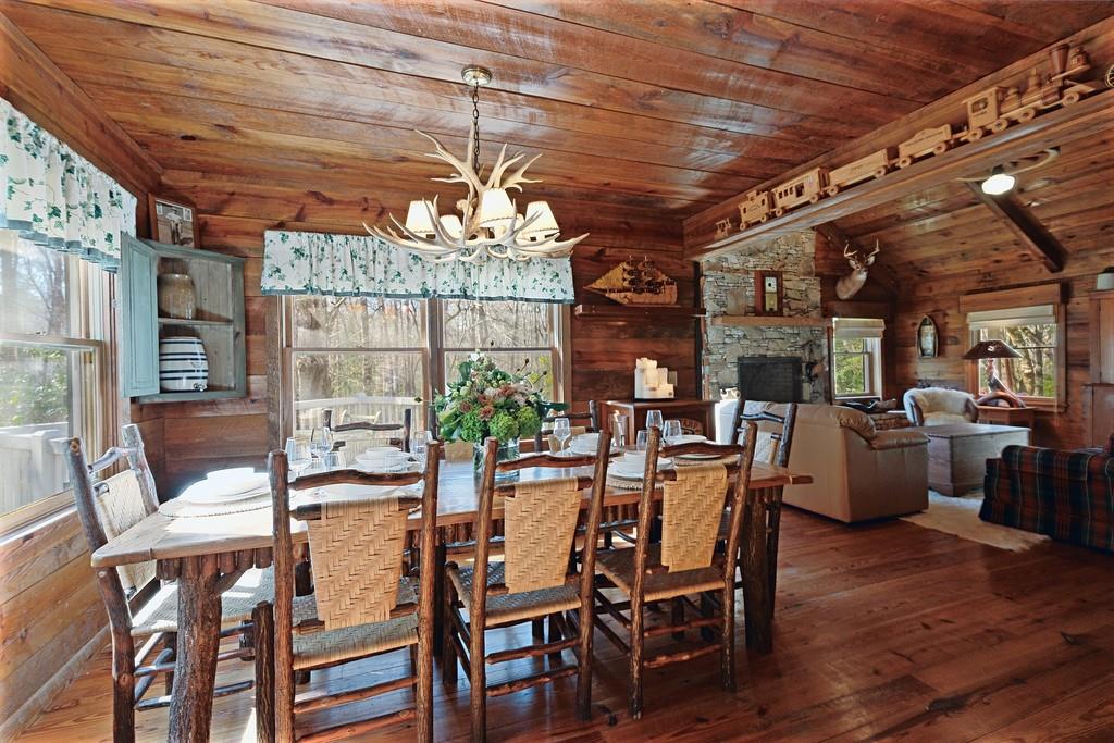 2320 Hardman Road Clarkesville, GA 30523 - Photo 32 of 53 a view of a dining room with furniture a chandelier and wooden floor