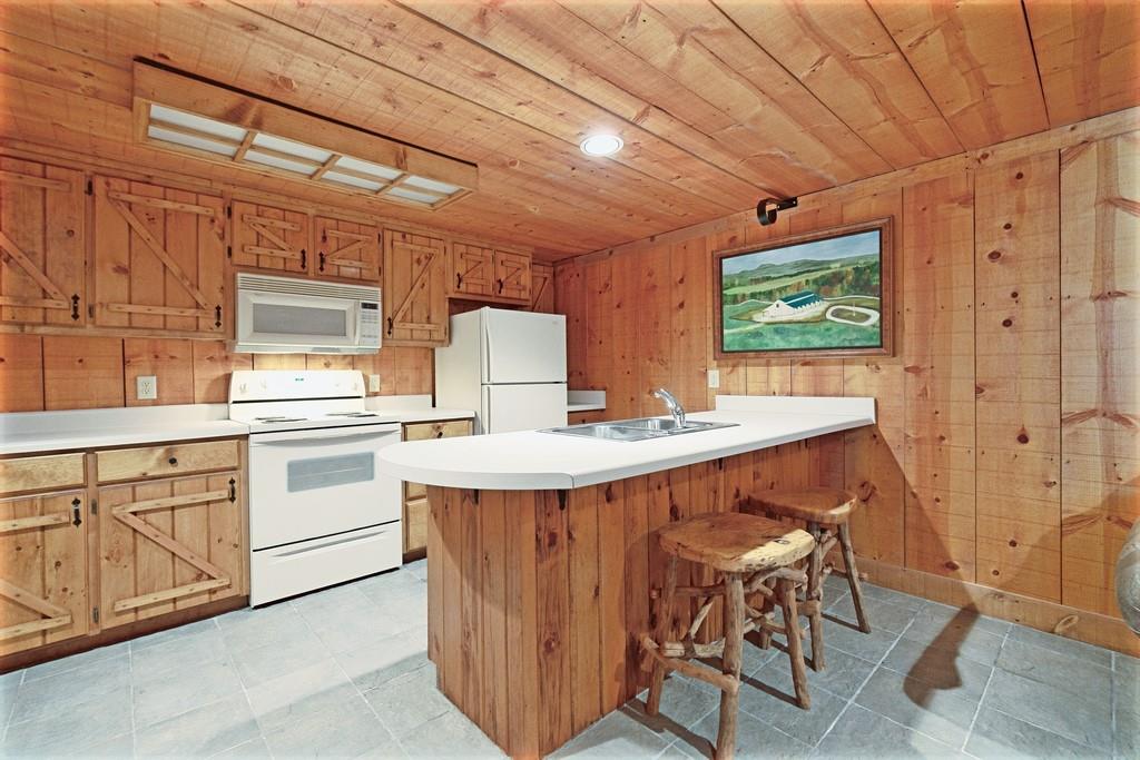 2320 Hardman Road Clarkesville, GA 30523 - Photo 45 of 53 a kitchen with a table chairs refrigerator and cabinets