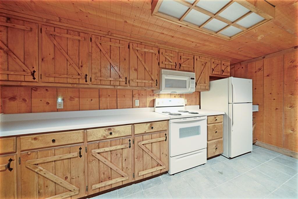 2320 Hardman Road Clarkesville, GA 30523 - Photo 46 of 53 a kitchen with cabinets and white appliances