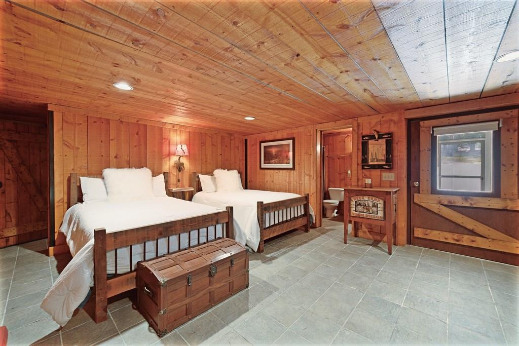 2320 Hardman Road Clarkesville, GA 30523 - Photo 51 of 53 a spacious bedroom with a bed a chandelier and a balcony view