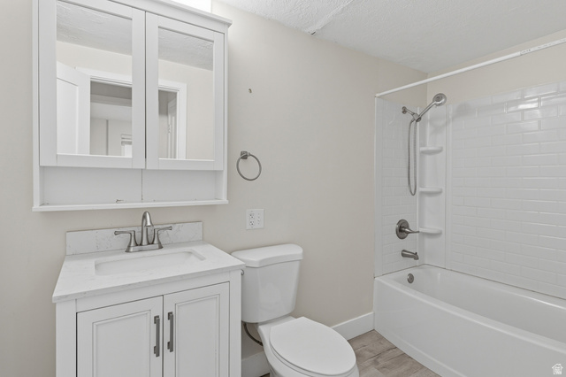 831 Lennox Street, Unit 5 Midvale, UT 84047 - Photo 14 of 19 Full bath with vanity, washtub / shower combination, a textured ceiling, and light wood finished floors