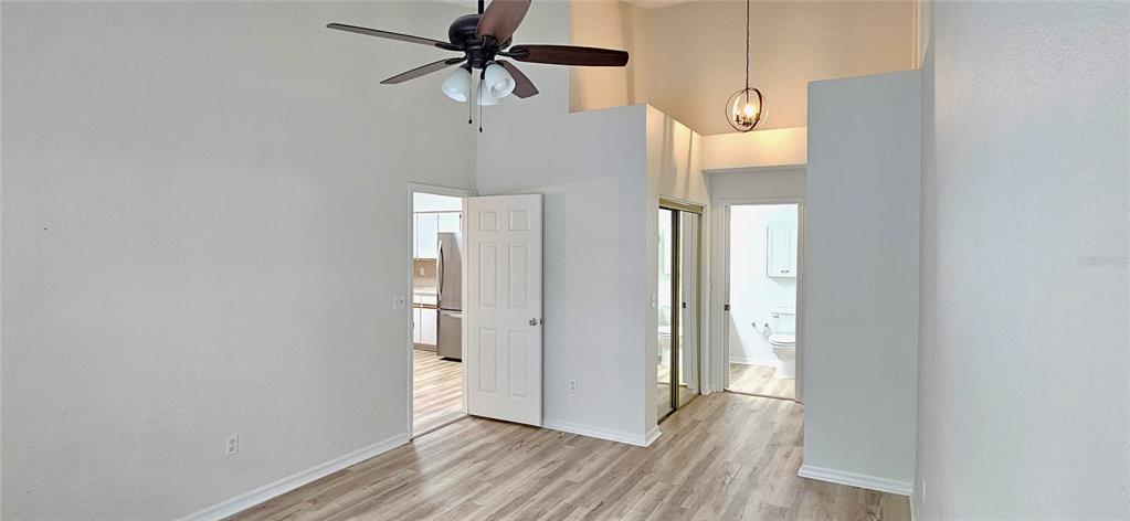 2736 Penzance Street Palm Harbor, FL 34684 - Photo 12 of 27 a view of a room with wooden floor and a ceiling fan