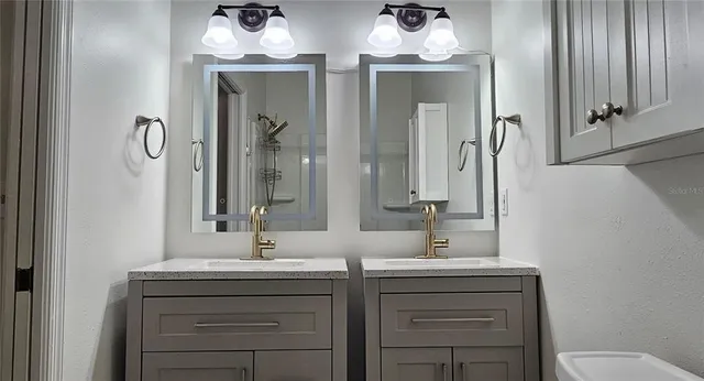 a bathroom with a double vanity sink and a mirror