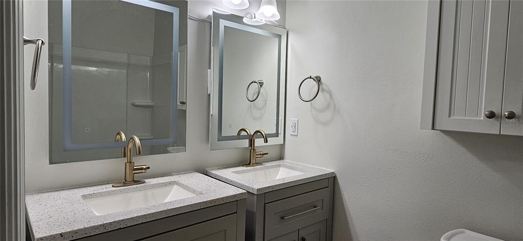 2736 Penzance Street Palm Harbor, FL 34684 - Photo 16 of 27 a bathroom with a sink and a mirror