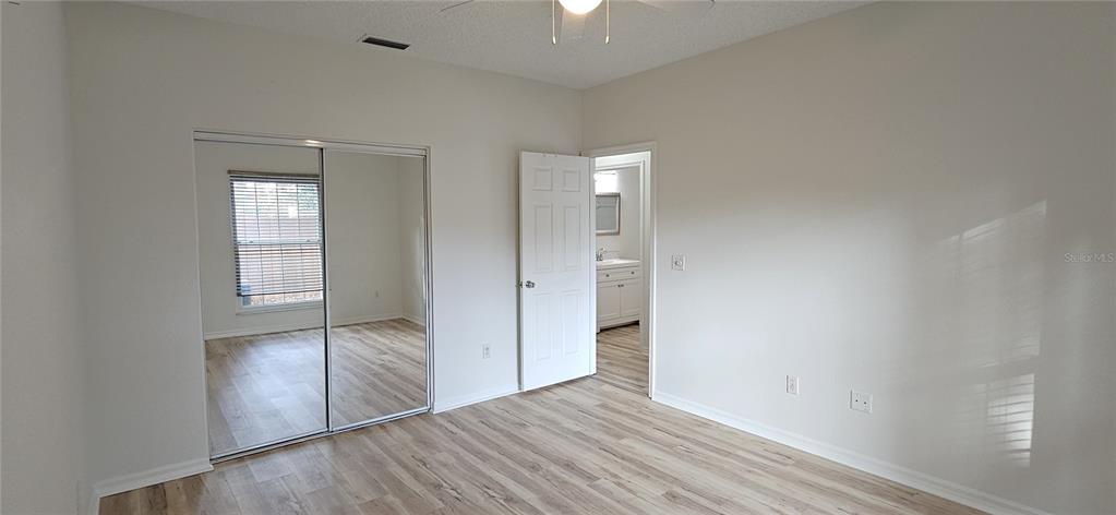 2736 Penzance Street Palm Harbor, FL 34684 - Photo 19 of 27 a view of an empty room with wooden floor and a window