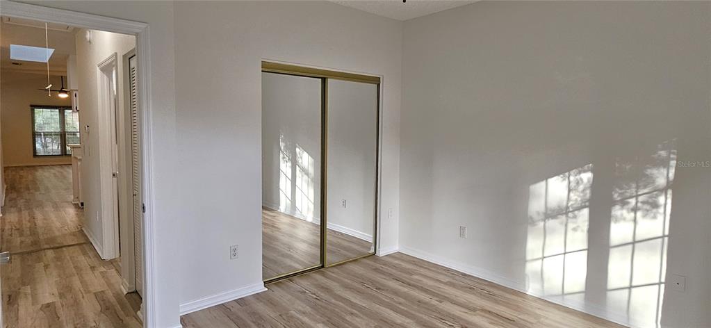 2736 Penzance Street Palm Harbor, FL 34684 - Photo 22 of 27 a view of empty room with wooden floor and fan