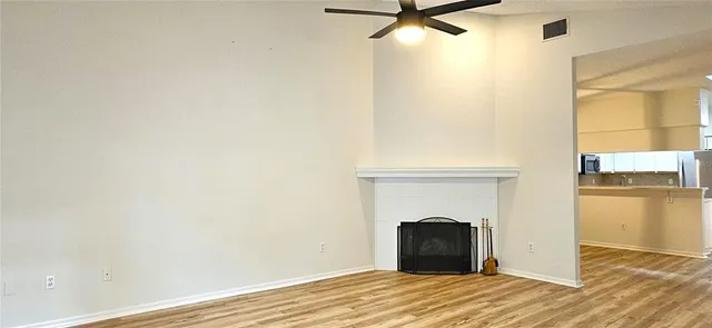 a view of a livingroom with a fireplace and wooden floor