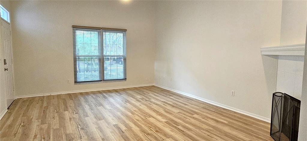 2736 Penzance Street Palm Harbor, FL 34684 - Photo 6 of 27 an empty room with wooden floor and windows