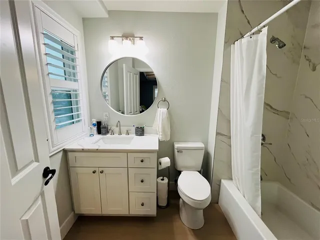 a bathroom with a toilet a sink and a mirror