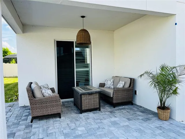 a living room with furniture and a potted plant