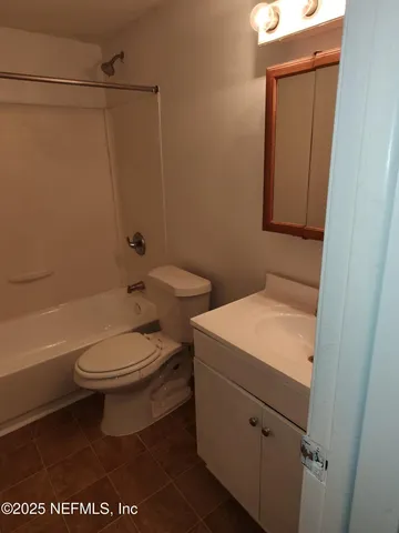 a bathroom with a toilet a sink and bathtub