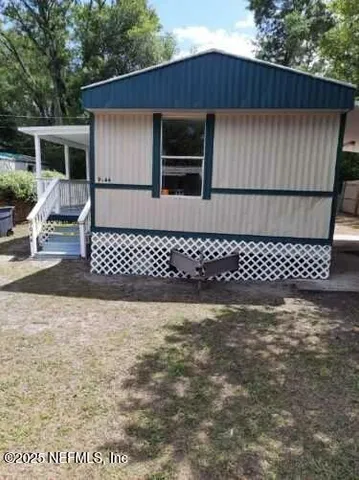 a view of a balcony with wooden floor and fence