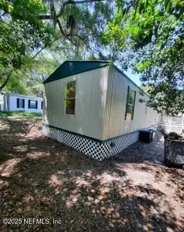 a backyard of a house with wooden fence