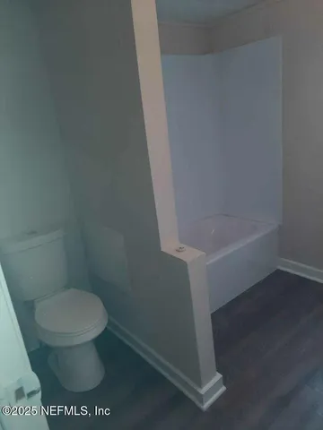 a white toilet sitting next to a sink
