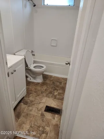 a view of wooden floor and windows in a room