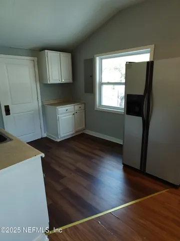 a room with a wooden floor and a window