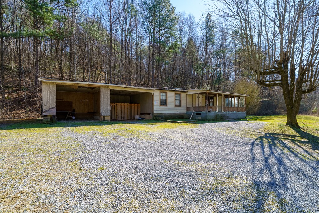7589 Tails Creek Road Ellijay, GA 30540 - Photo 27 of 44 a view of a house with backyard and tree