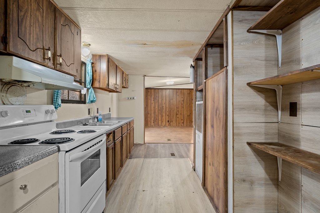 7589 Tails Creek Road Ellijay, GA 30540 - Photo 35 of 44 a kitchen with stainless steel appliances granite countertop a stove and a refrigerator