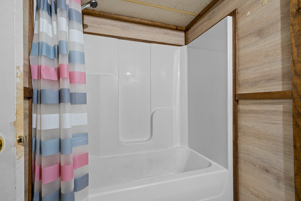 7589 Tails Creek Road Ellijay, GA 30540 - Photo 42 of 44 a bathroom with a bathtub and shower