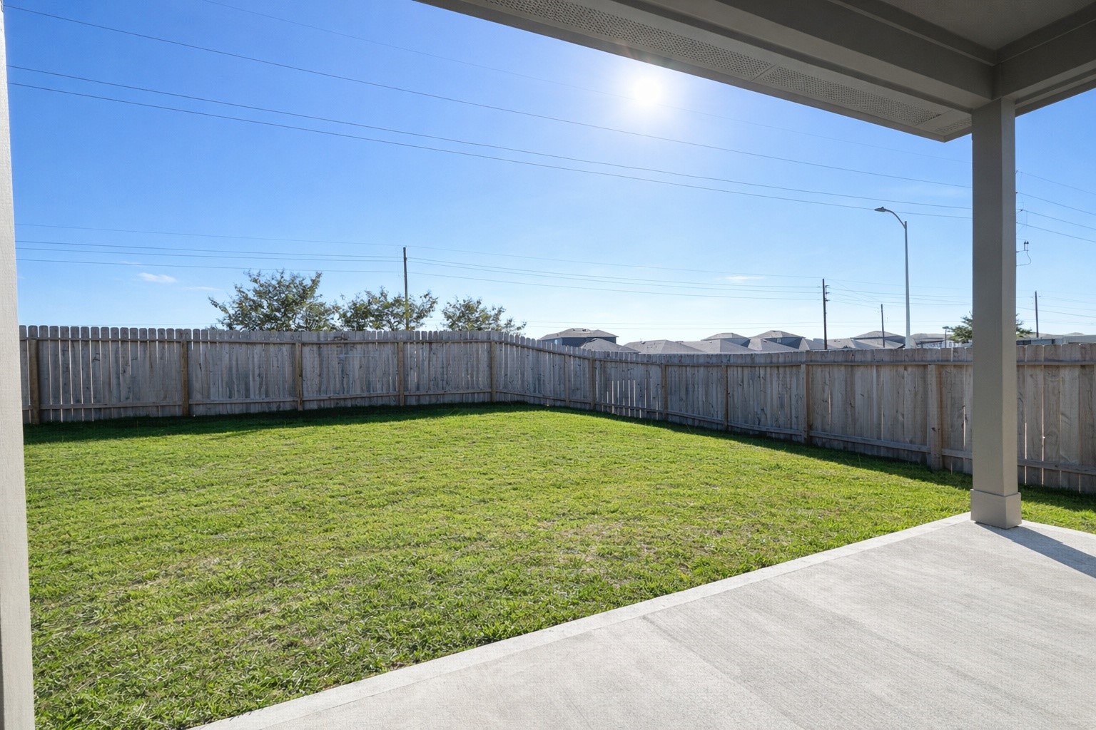 1739 Royal Rim Drive Houston, TX 77014 - Photo 19 of 20 Spacious backyard with a well-maintained lawn, enclosed by a wooden fence, and a covered patio area perfect for outdoor relaxation.