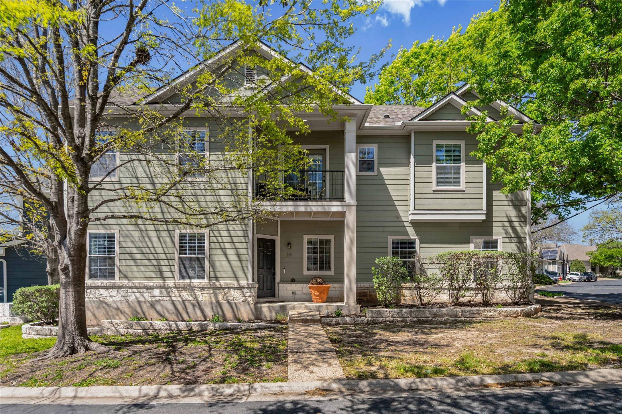 View of front of property with a balcony and covered porch