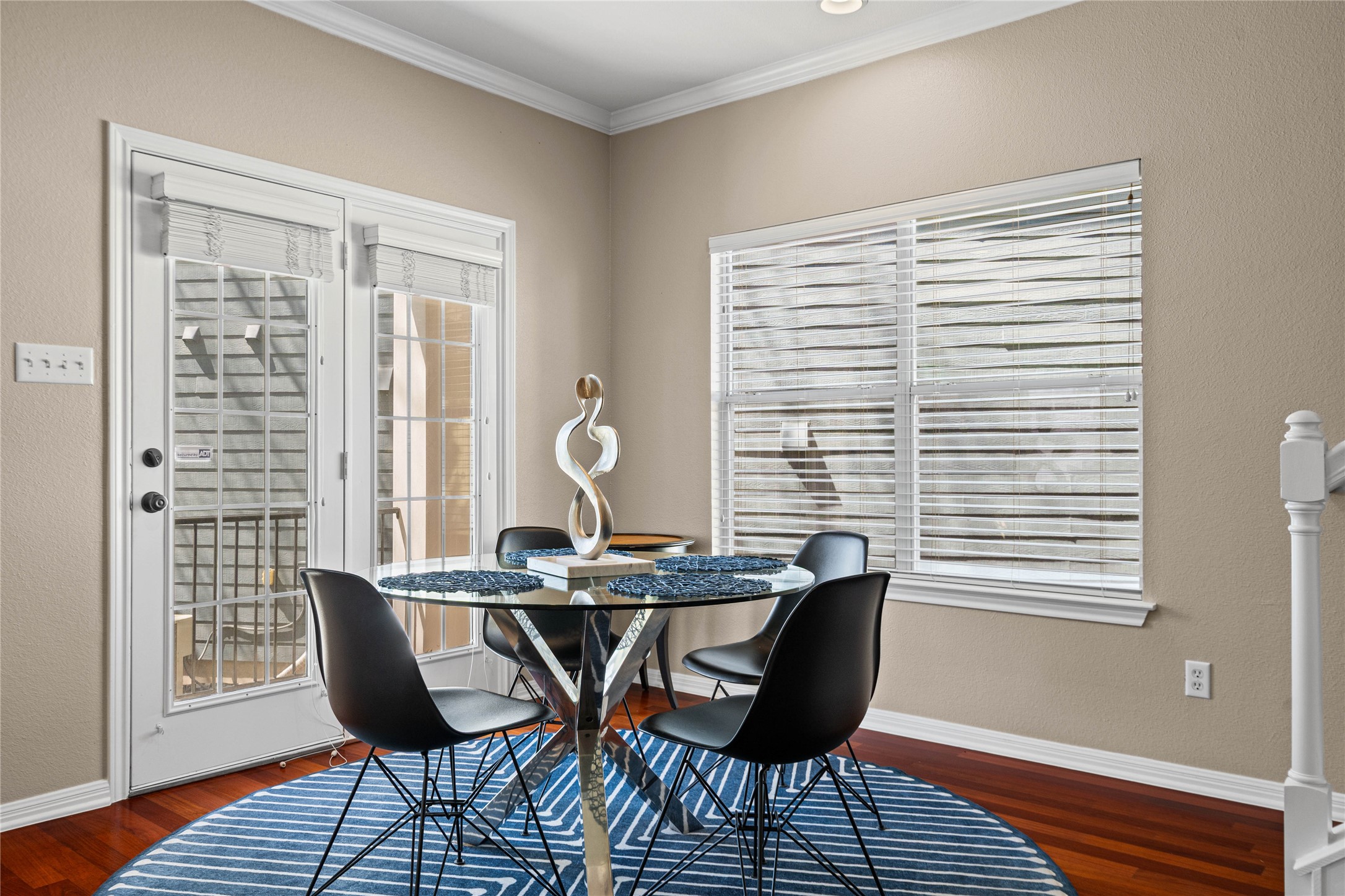 411 West St Elmo Road, Unit 24 Austin, TX 78745 - Photo 11 of 29 Dining space featuring ornamental molding, dark wood-type flooring, and a textured wall