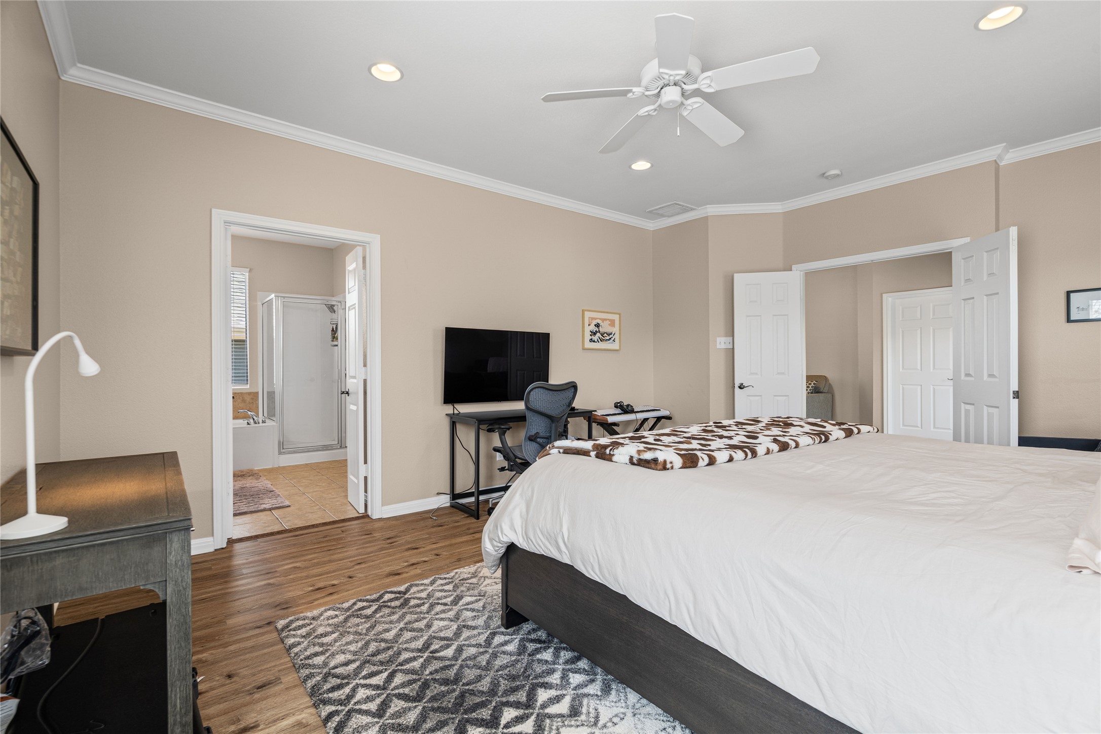 411 West St Elmo Road, Unit 24 Austin, TX 78745 - Photo 16 of 29 Bedroom with recessed lighting, ornamental molding, dark wood finished floors, ceiling fan, and ensuite bathroom