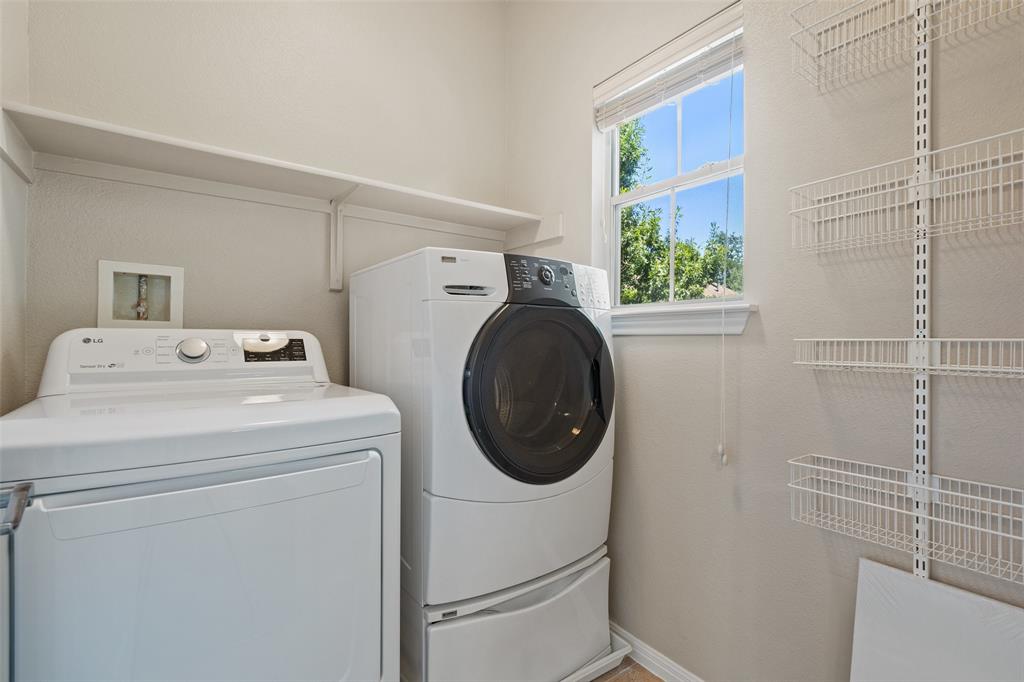 411 West St Elmo Road, Unit 24 Austin, TX 78745 - Photo 21 of 29 Laundry room featuring separate washer and dryer and baseboards