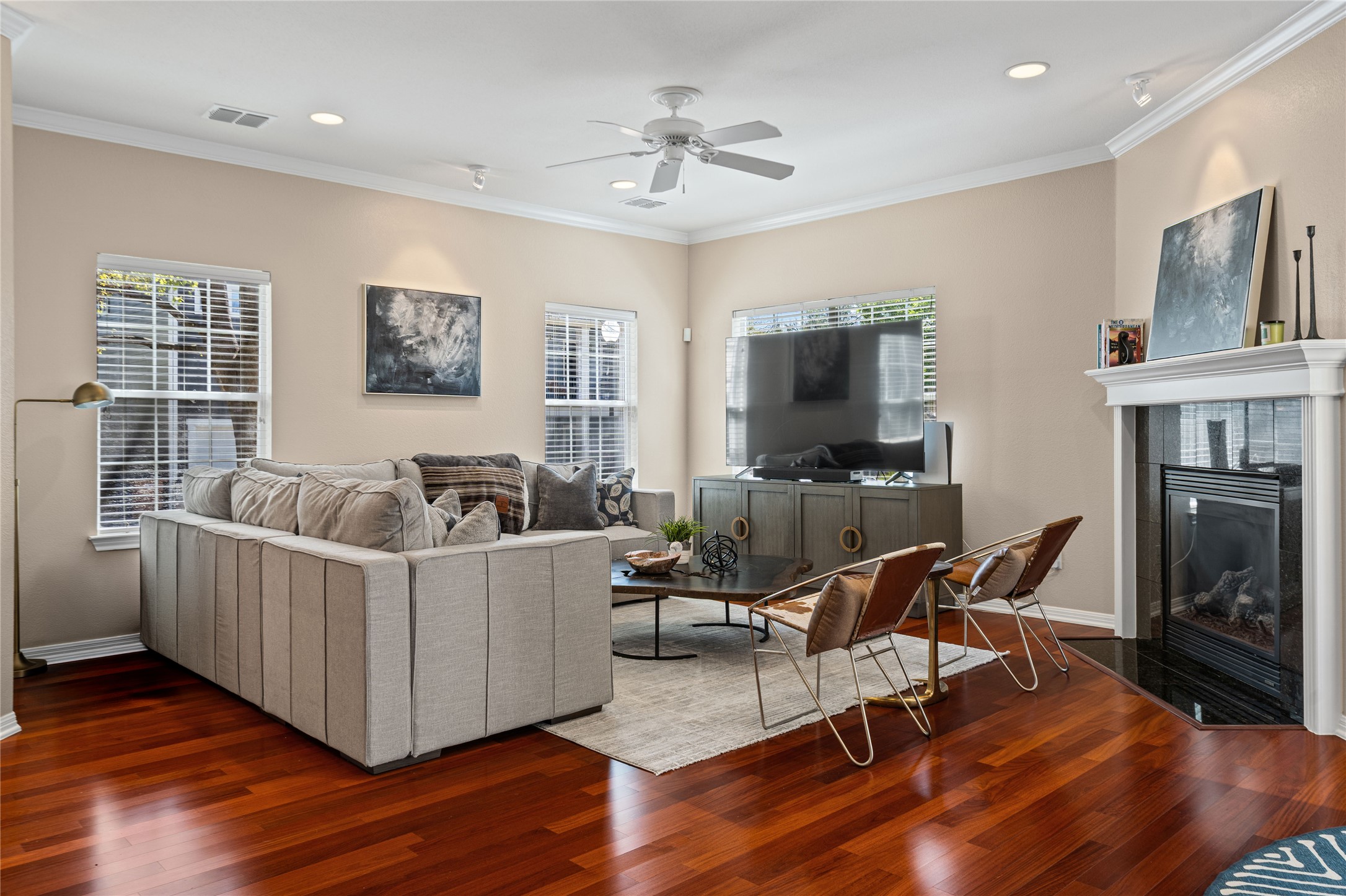 411 West St Elmo Road, Unit 24 Austin, TX 78745 - Photo 5 of 29 Living room with ornamental molding, ceiling fan, a tile fireplace, hardwood / wood-style floors, and recessed lighting