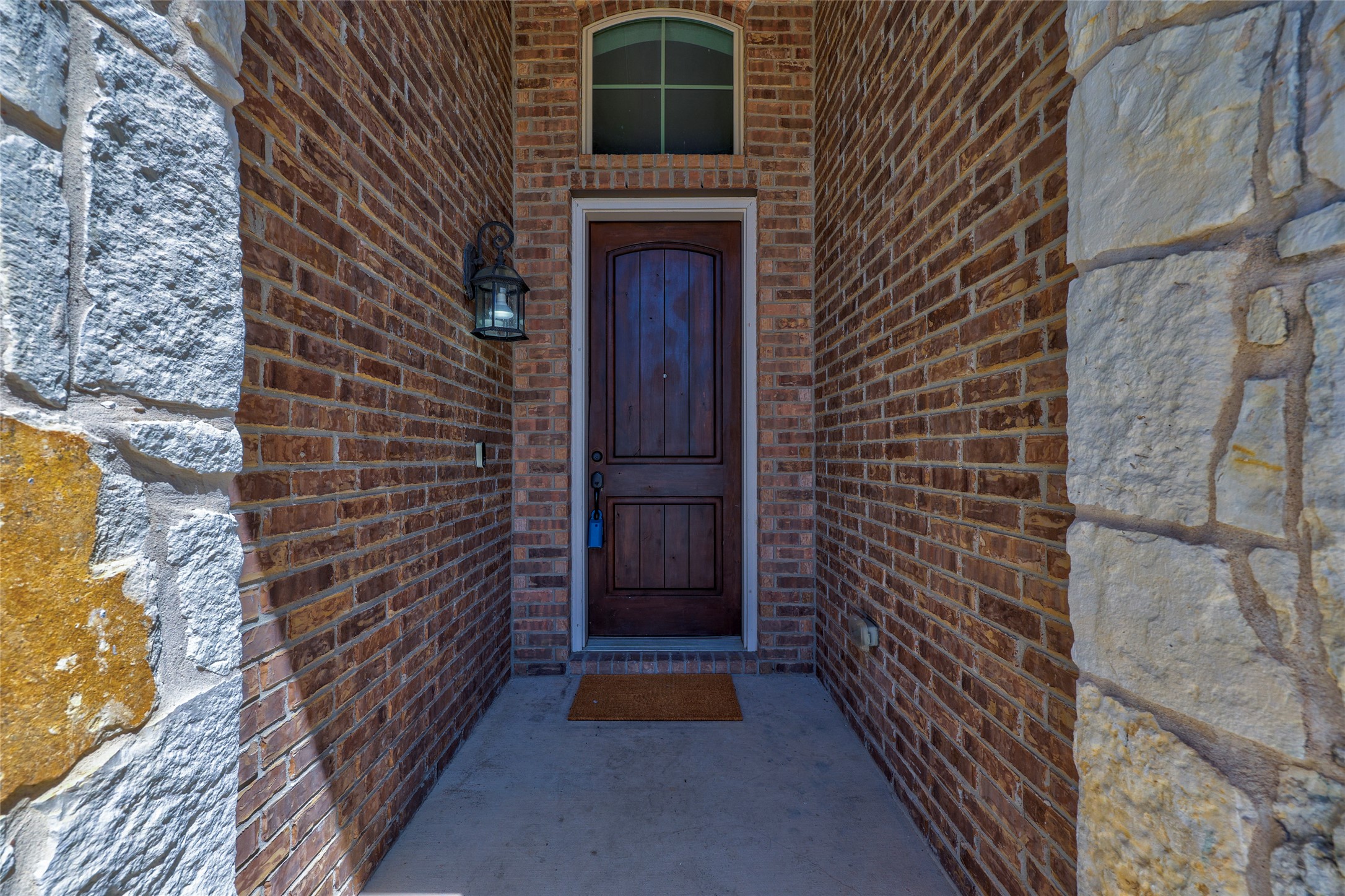 409 Betony Loop Buda, TX 78610 - Photo 1 of 38 A welcoming entryway combines natural stone and brick, leading to a rich wood door.