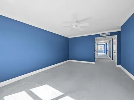 a spacious bedroom with two beds and painting on the wall