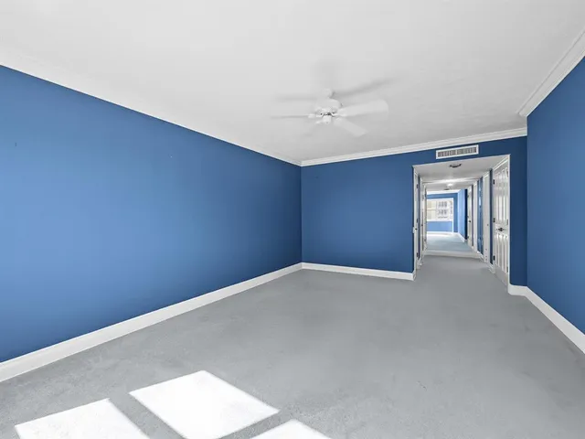 a spacious bedroom with two beds and painting on the wall