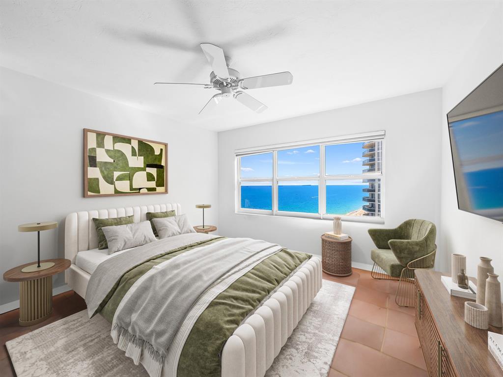 3400 Galt Ocean Drive, Unit 1202S Fort Lauderdale, FL 33308 - Photo 23 of 36 a bedroom with a large bed and a chandelier