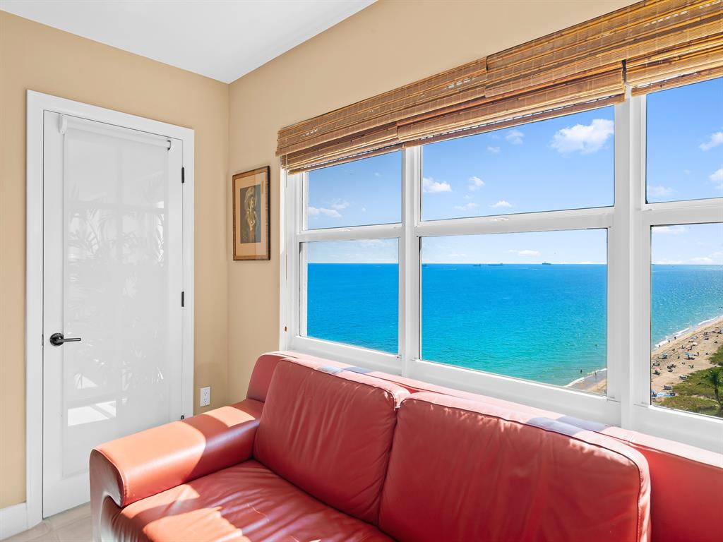 3400 Galt Ocean Drive, Unit 1202S Fort Lauderdale, FL 33308 - Photo 25 of 36 a blue bed sitting in a bedroom next to a window