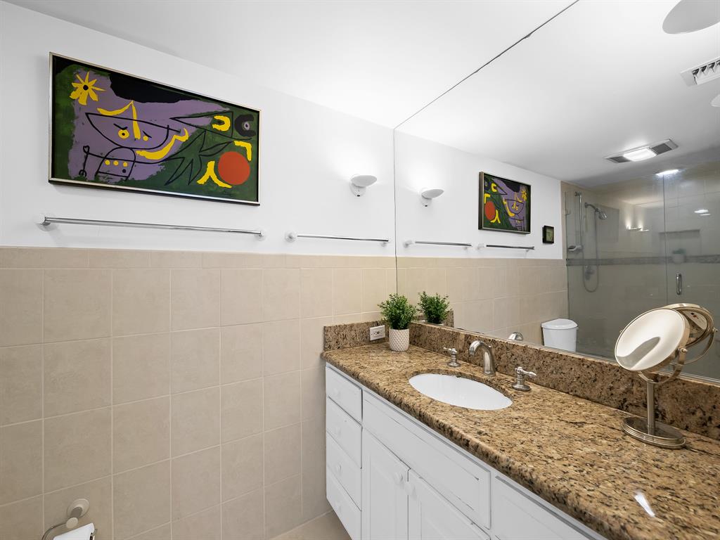 3400 Galt Ocean Drive, Unit 1202S Fort Lauderdale, FL 33308 - Photo 26 of 36 a bathroom with a granite countertop sink and a mirror