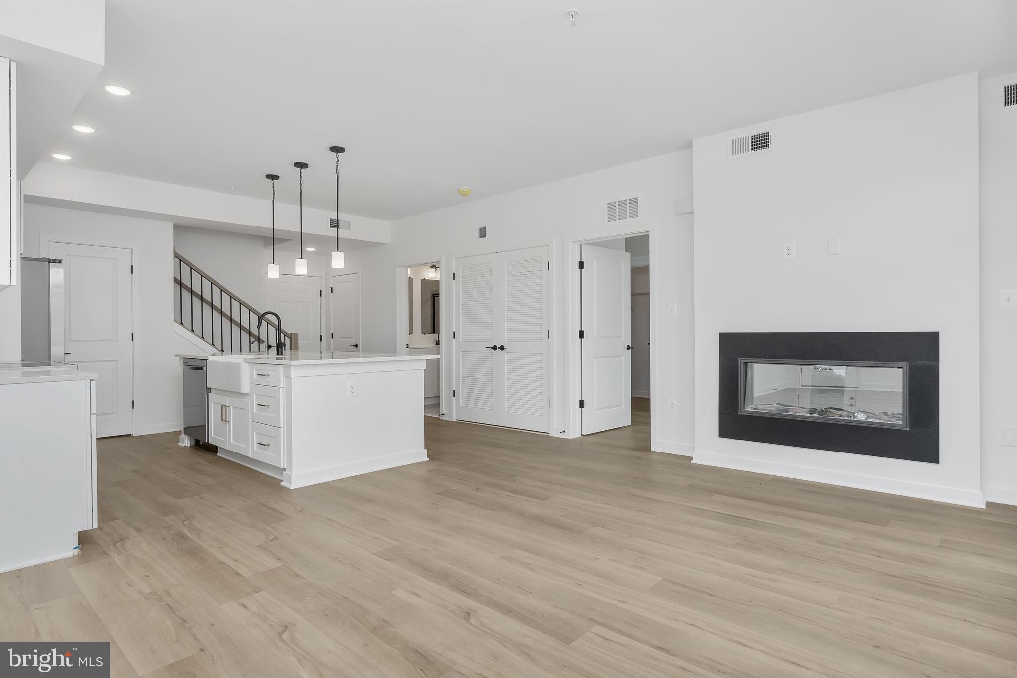 711 Iron Frg Road, Unit C Frederick, MD 21702 - Photo 7 of 15 a view of a big room with wooden floor and windows