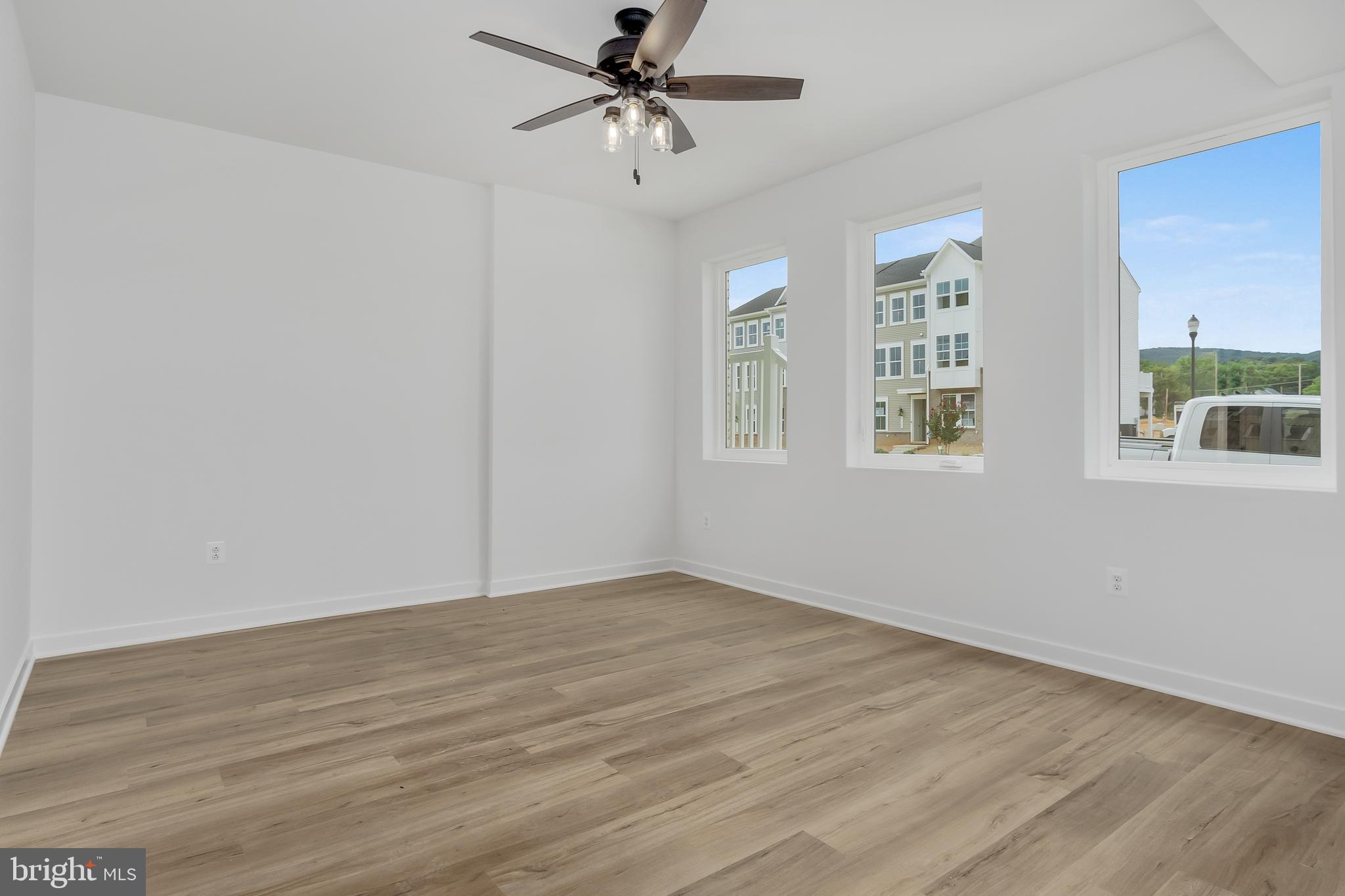 711 Iron Frg Road, Unit C Frederick, MD 21702 - Photo 8 of 15 wooden floor in an empty room with a window