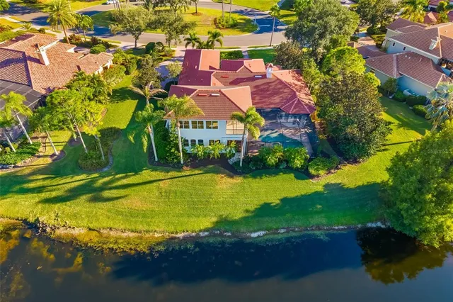 an aerial view of a house with swimming pool and garden