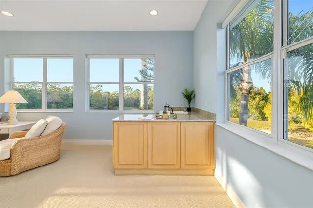 a view of a lake with a bench and trees around