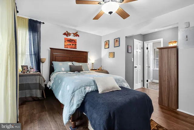 a bedroom with a large bed and a chandelier