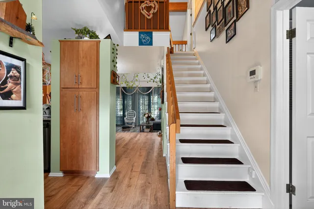 a view of a room with stairs and wooden floor