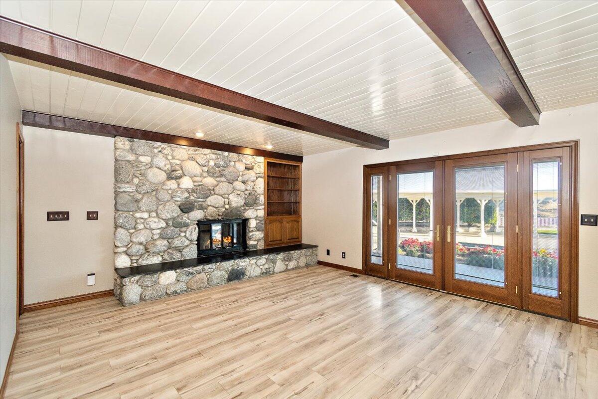 13292 Revello Road Redlands, CA 92373 - Photo 26 of 81 a view of an empty room with wooden floor and a window