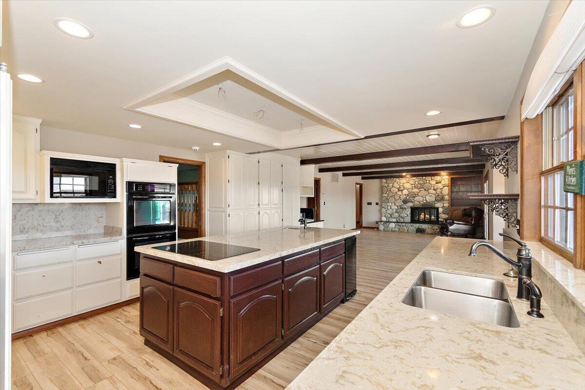 13292 Revello Road Redlands, CA 92373 - Photo 29 of 81 a large kitchen with stainless steel appliances granite countertop a large counter top and a stove with wooden floor