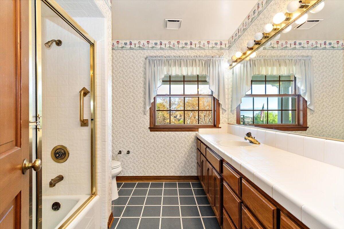 13292 Revello Road Redlands, CA 92373 - Photo 49 of 81 a bathroom with a tub sink and mirror
