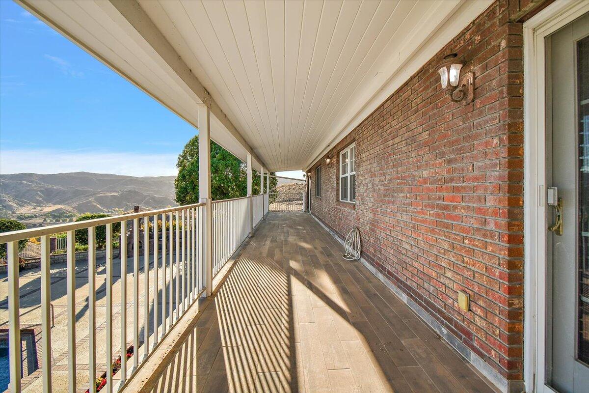 13292 Revello Road Redlands, CA 92373 - Photo 70 of 81 a view of a balcony with wooden floor and fence