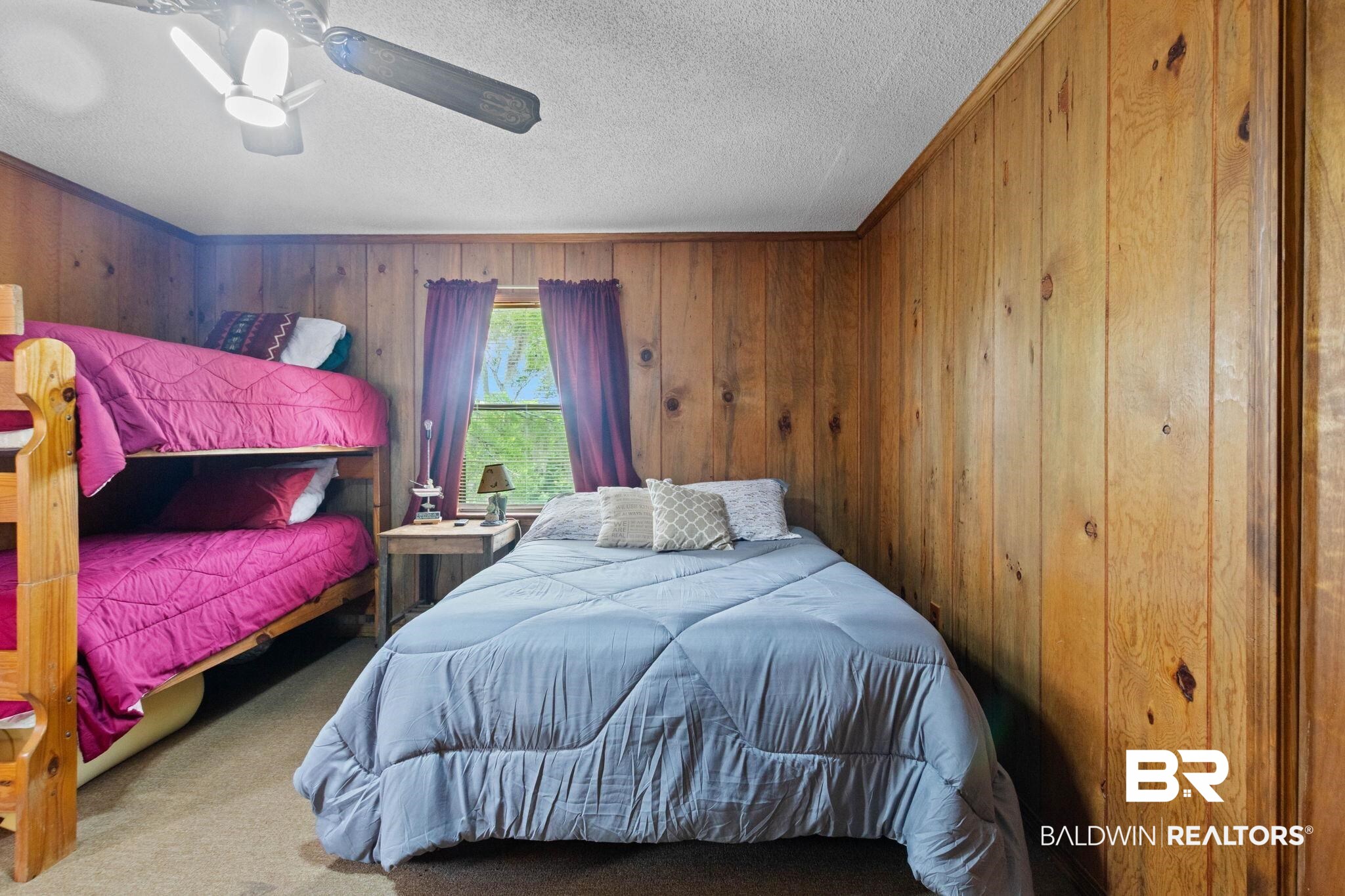 8153 Bryant's Lndg Road Stockton, AL 36579 - Photo 43 of 87 Room featuring wood-paneled walls, a single window with curtain rods, and a ceiling fan with integrated lighting