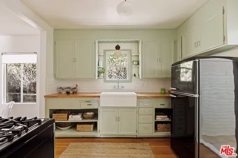 a kitchen with stainless steel appliances a refrigerator stove and sink