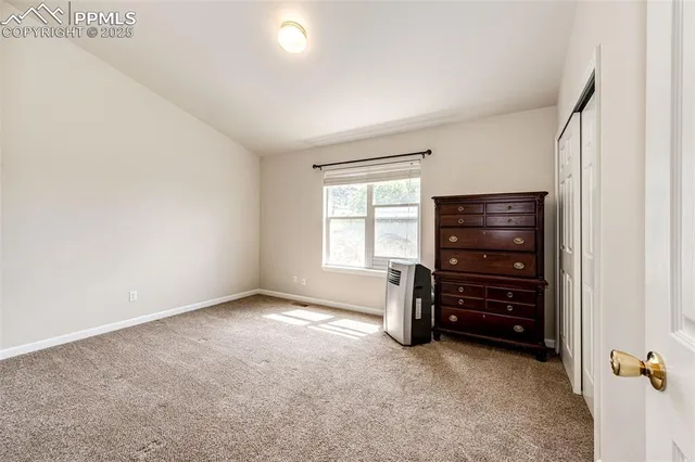 an empty room with furniture and a window